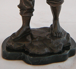 Farm boy statue feet